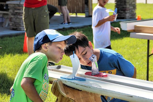 2 Scouts Blowing Boats in a Raingutter Regatta